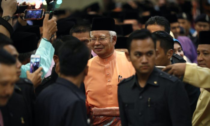 Malaysian Prime Minister Najib Razak, center, arrives for an Eid al-Fitr open house event in Kuala Lumpur, Malaysia, Thursday, July 21, 2016.  (AP Photo/Vincent Thian)