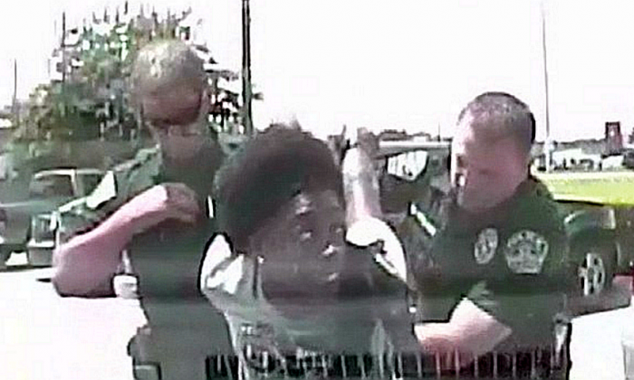 Two Texas police officers are under investigation after a video captured the moment one of them body slammed a black female school teacher to the ground in an arrest. 