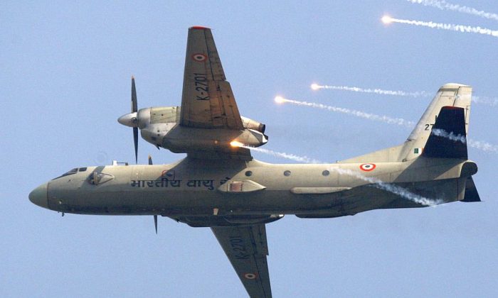 In this Thursday, Oct. 8, 2009, file photo, an Indian Air Force's (IAF) AN-32 transport aircraft releases chaff as it flies past the IAF Day Parade in New Delhi, India. (AP Photo/Mustafa Quraishi, file)