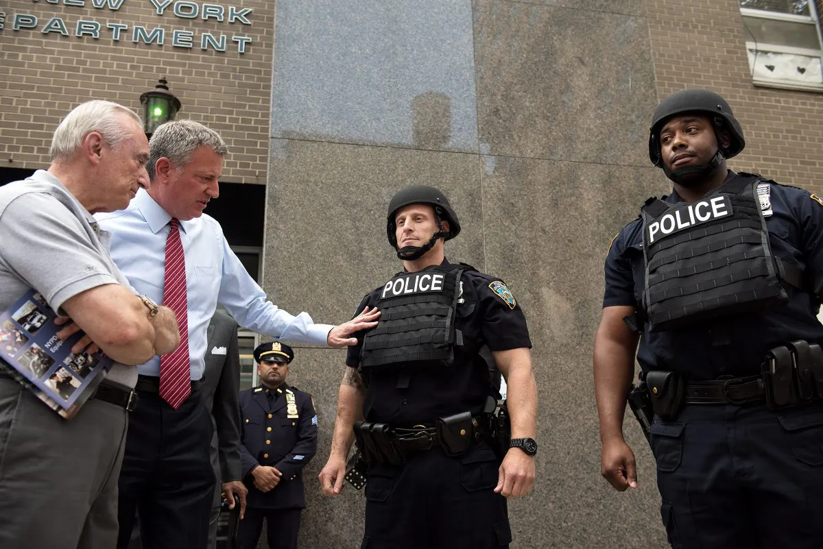 (L-R) NYPD Police Commissioner William Bratton and New York City Mayor Bill de Blasio inspect new NYPD equipment including helmets and vest during a press conference at the 84th Precinct in Brooklyn, New York, on Monday, July 25, 2016. (Demetrius Freeman/Mayoral Photography Office)