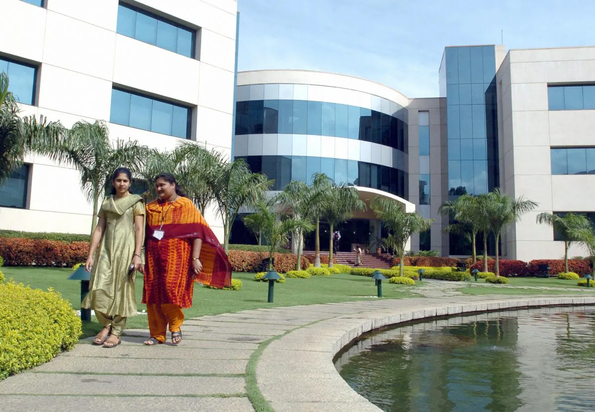 Employees of India software giant Infosys Technologies walk inside the company's compound in Bangalore on April 14, 2005. (Dibyangshu Sarkar/AFP/Getty Images)