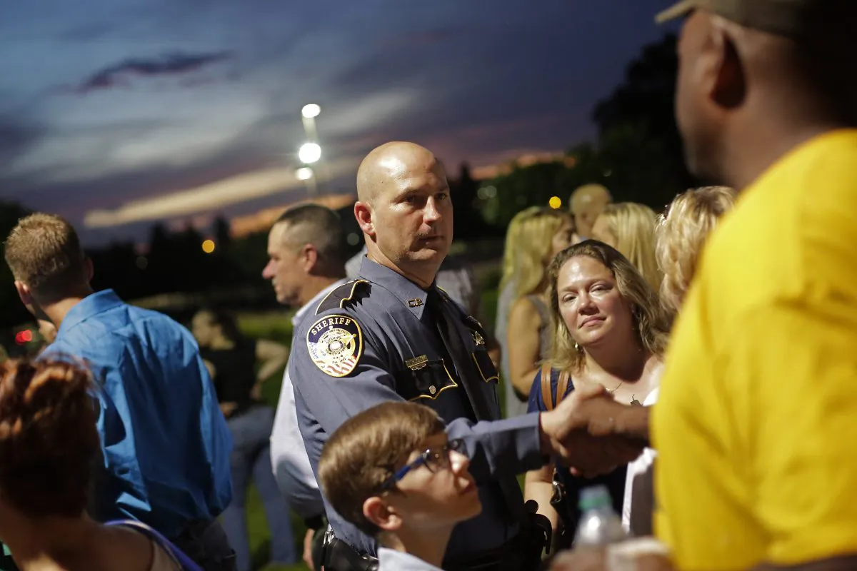 A police officer is greeted during a candlelight vigil for Baton Rouge Police Officer Matthew Gerald at Healing Place Church in Baton Rouge, La., on July 18, 2016. Gerald was one of three police officers killed by Gavin Long, who traveled from Kansas City, Mo., ambushing law enforcement officers along Airline Highway Sunday morning, July 17. (Joshua Lott/Getty Images)