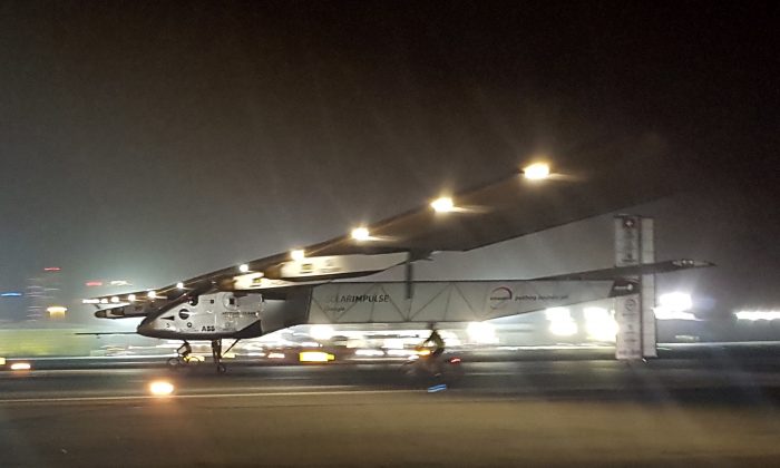 The Solar Impulse 2 plane lands in an airport in Abu Dhabi, United Arab Emirates, early Tuesday, July 26, 2016, marking the historic end of the first attempt to fly around the world without a drop of fuel, powered solely by the sun’s energy.  Solar Impulse Chairman and pilot Bertrand Piccard was at the controls of the single-seater when it landed at the Al Bateen Executive Airport. Piccard traded off piloting with co-founder Andre Borschberg in the epic journey that took more than a year to complete. (AP Photo/Aya Batrawy)