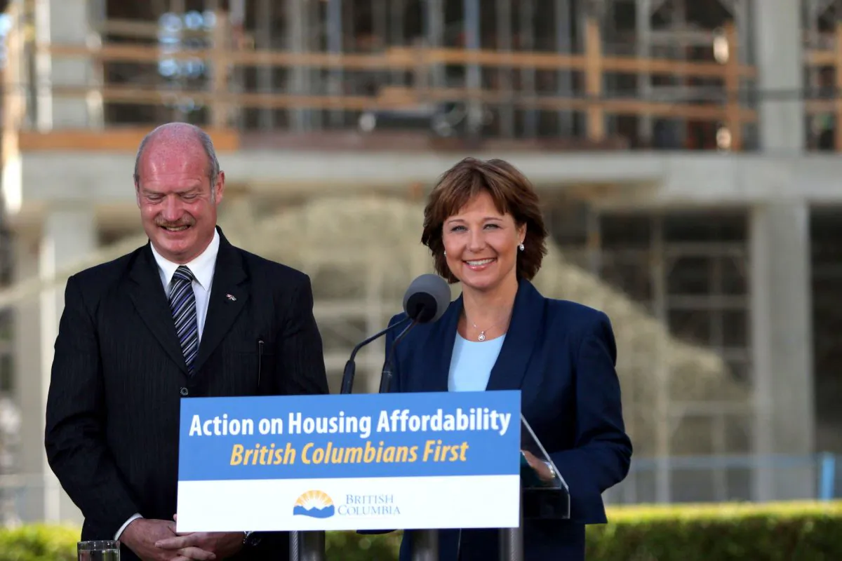 Premier Christy Clark and Finance Minister Mike de Jong discuss amendments regarding housing issues in Greater Vancouve during a press conference at the Victoria Legislature on July 25, 2016. (The Canadian Press/Chad Hipolito)