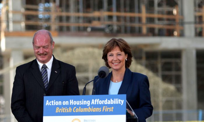 Premier Christy Clark and Finance Minister Mike de Jong discuss amendments regarding housing issues in Greater Vancouve during a press conference at the Victoria Legislature on July 25, 2016. (The Canadian Press/Chad Hipolito)