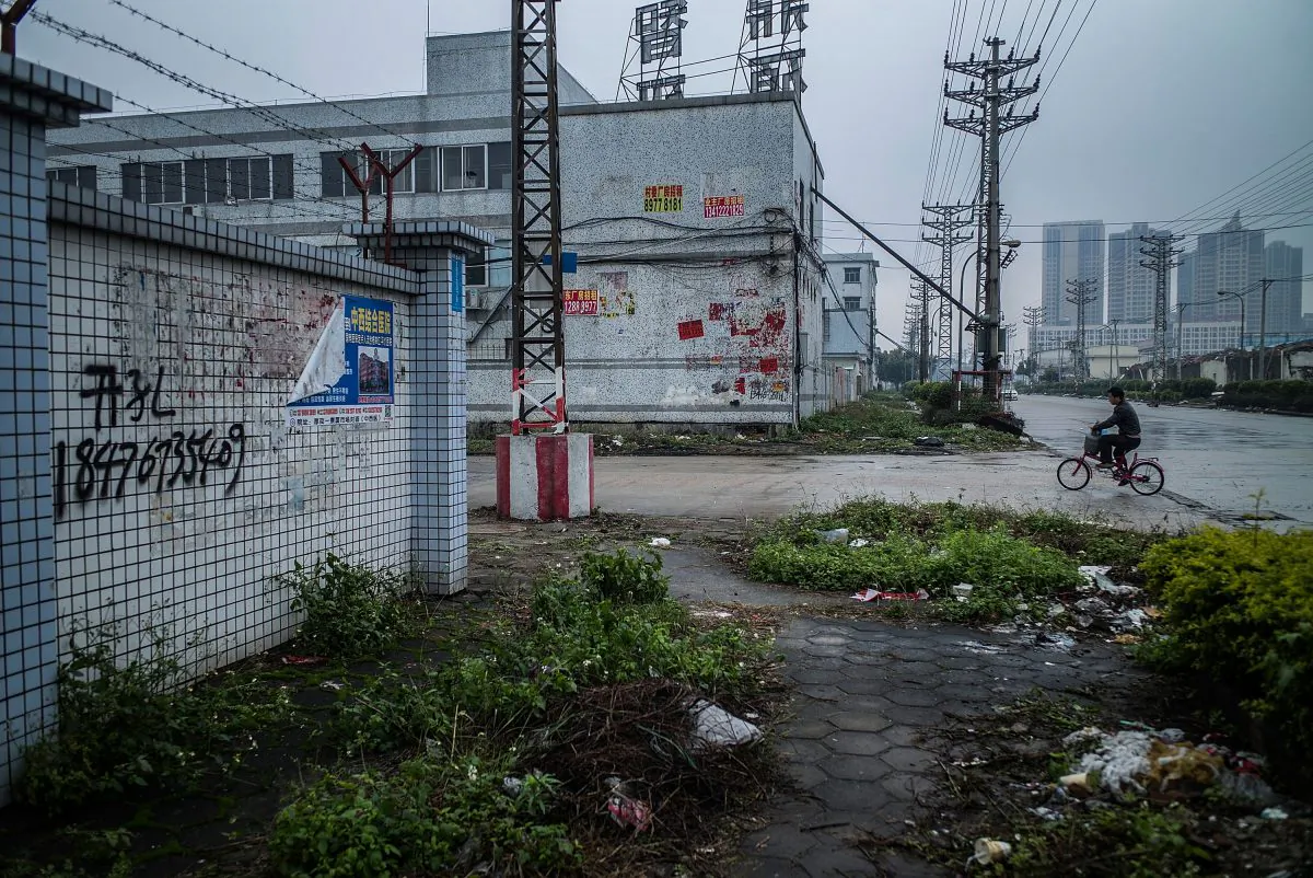 A man rides a bicycle at an abandoned industrial area of Houjie town in Dongguan on Jan. 27, 2016. (Lam Yik Fei/Getty Images)