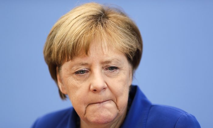 German Chancellor Angela Merkel attends a news conference in Berlin Thursday, July 28, 2016 . Chancellor Angela Merkel says the fact that two men who came to Germany as refugees carried out attacks claimed by the Islamic State group "mocks the country that took them in." Merkel pledged at a news conference to do everything to clear up the "barbaric acts," find out who was behind them and bring them to justice. (AP Photo/Markus Schreiber)