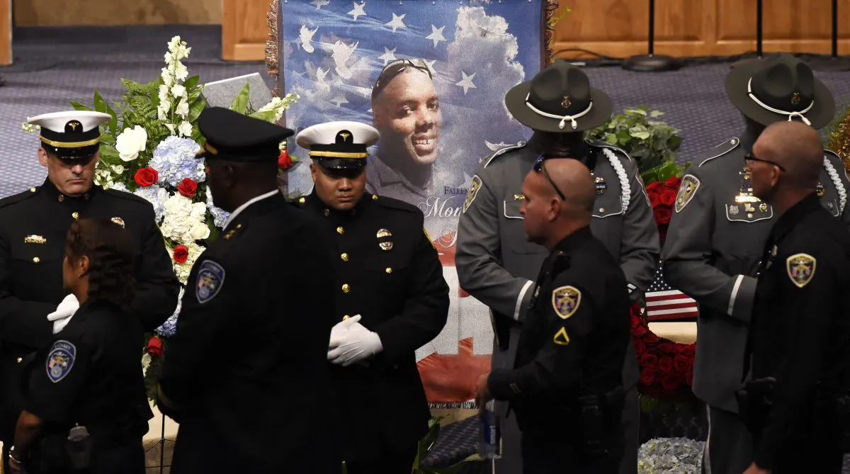 Police officers pay their respects during the funeral of slain Baton Rouge police corporal Montrell Jackson at the Living Faith Christian Center July 25, 2016 in Baton Rouge, Louisiana. (Bill Feig-Pool/Getty Images)