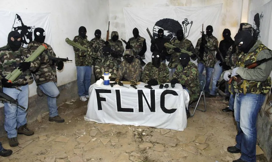 -, FRANCE: Picture taken in an undisclosed location in Southern Corsica at the end of October 2006 showing four spokesmen of the outlawed National Liberation Front of Corsica (FNLC) flanked by armed and hooded militants holding a press conference in a remote farm with two Corsican journalists (out of camera range). Corsican militants have been waging a long and low-level violent struggle for independence or autonomy since the 1970s. AFP PHOTO STEPHAN AGOSTINI (Photo credit should read STEPHAN AGOSTINI/AFP/Getty Images)