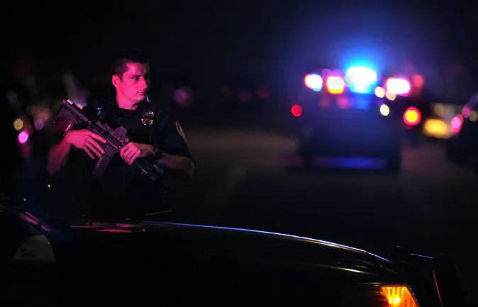 A San Diego Harbor Police officer helps to secure the scene near the corner of 39th Street and Boston Avenue in San Diego near where two San Diego Police officers were shot Thursday night, July 28, 2016. (John Gastaldo/The San Diego Union-Tribune via AP)