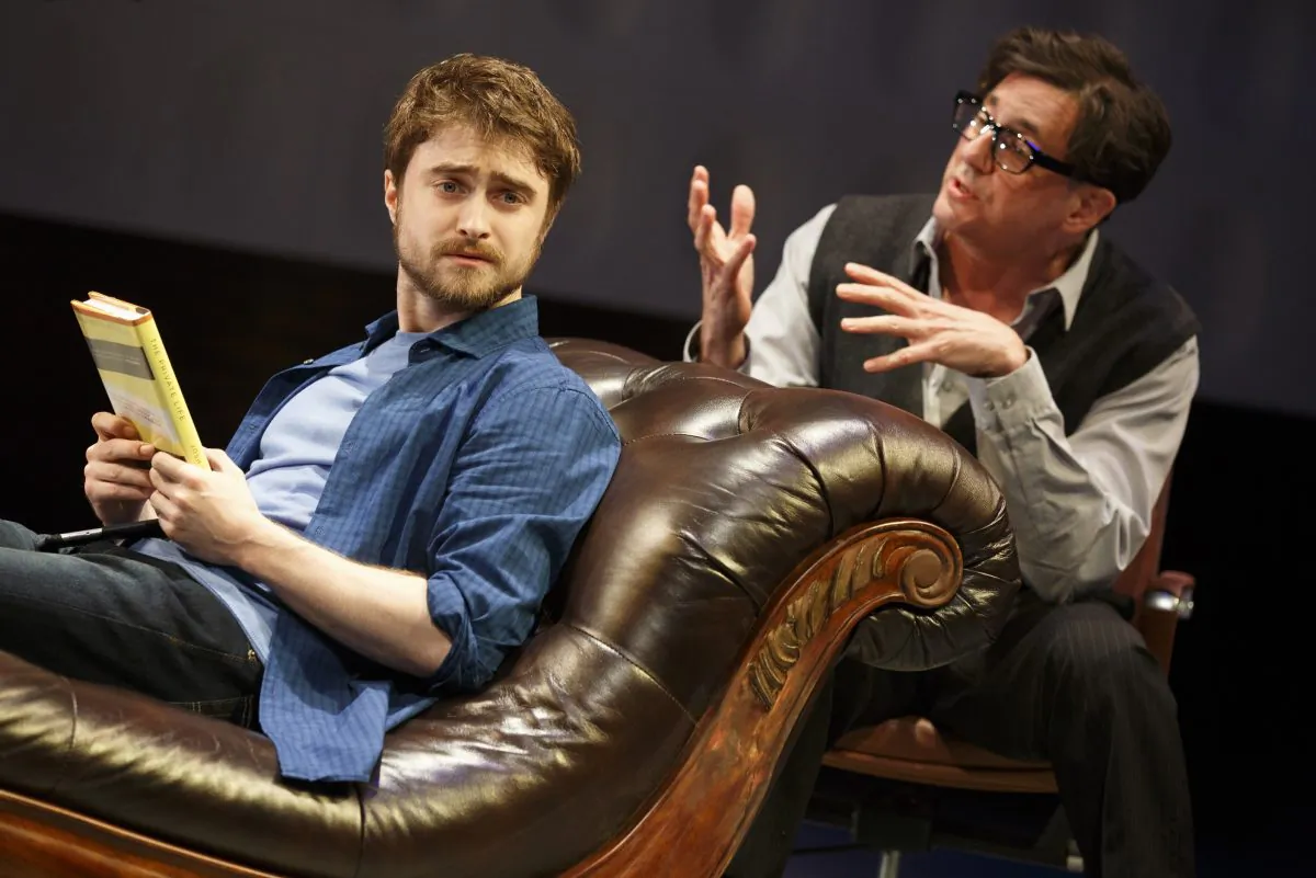 (L–R) Writer (Daniel Radcliffe) has writer’s block and his therapist (Reg Rogers) is trying to help him through it—if only the social media wasn’t getting way, in The Public Theater and Donmar Warehouse’s co-production of  “Privacy.” (Joan Marcus)