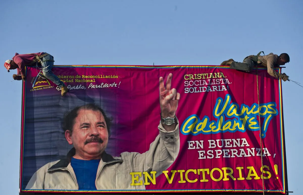 Workers install a billboard supporting Nicaragua's President Daniel Ortega along a street in Managua, Nicaragua, on Dec. 21, 2015. The opposition claims the presidential election in 2016 was a fraud as Ortega demonstrates many facets of a classic Latin American dictator. (AP Photo/Esteban Felix)