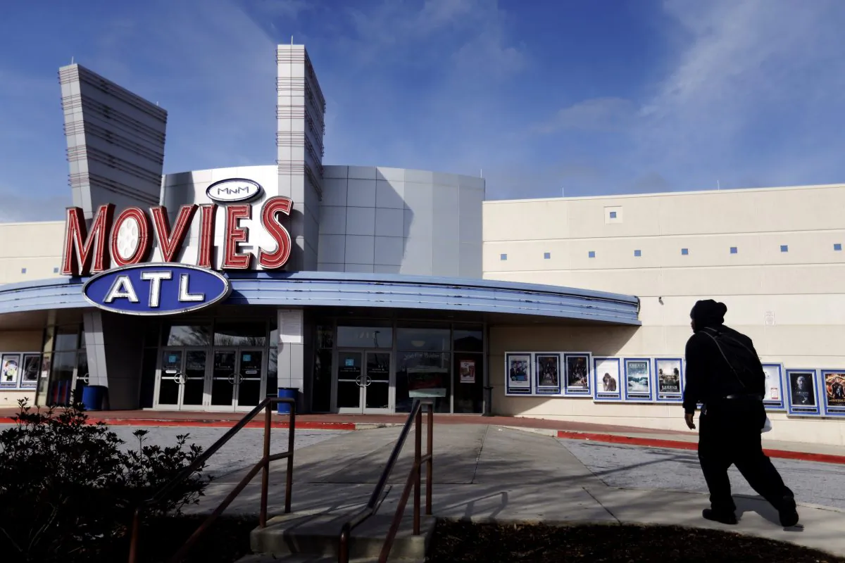 A patron walks into a Carmike Cinemas movie theater in Atlanta on Dec. 17, 2014. (AP Photo/David Goldman)