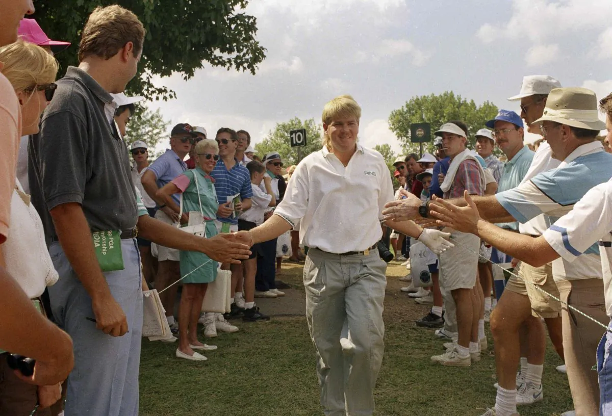 John Daly of Memphis, Tenn., is greeted by spectators on his way to the tenth tee during final round action of the PGA Championship in Carmel, Indiana on Sunday, August 11, 1991. (AP Photo/Ron Heflin) 