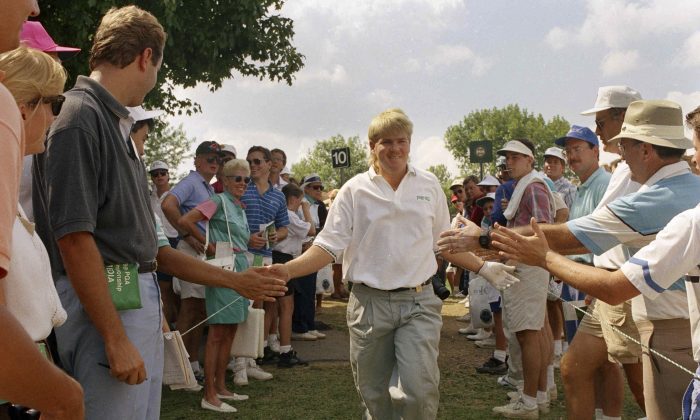 John Daly of Memphis, Tenn., is greeted by spectators on his way to the tenth tee during final round action of the PGA Championship in Carmel, Indiana on Sunday, August 11, 1991. (AP Photo/Ron Heflin) 