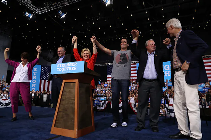 (L-R) Anne Holton, democratic vice presidential nominee U.S. Sen Tim Kaine (D-VA), democratic presidential nominee former Secretary of State Hillary Clinton, Mark Cuban, U.S. Rep. Mike Doyle (D-PA) and former U.S. president Bill Clinton raise arms during a campaign rally  at the David L. Lawrence Convention Center on July 30, 2016 in Pittsburgh, Pennsylvania. (Photo by Justin Sullivan/Getty Images)