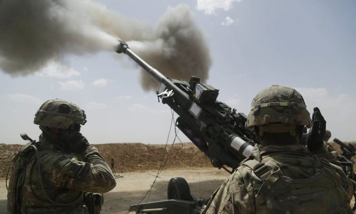 U.S. soldiers with 1st Battalion, 320th Field Artillery Regiment, 2nd Brigade Combat Team, 101st Airborne Division (Air Assault), fire an M777 howitzer at Kara Soar Base, Iraq, on May 23, 2016. Some 560 American military personnel, mainly engineers and logistics, security and communications experts, are due to deploy to northern Iraq upgrade its facilities to prepare for a large military operation to re-take Mosul from the Islamic State, according to U.S. Defense Secretary Ash Carter. (Sgt. Paul Sale/U.S. Army via AP)