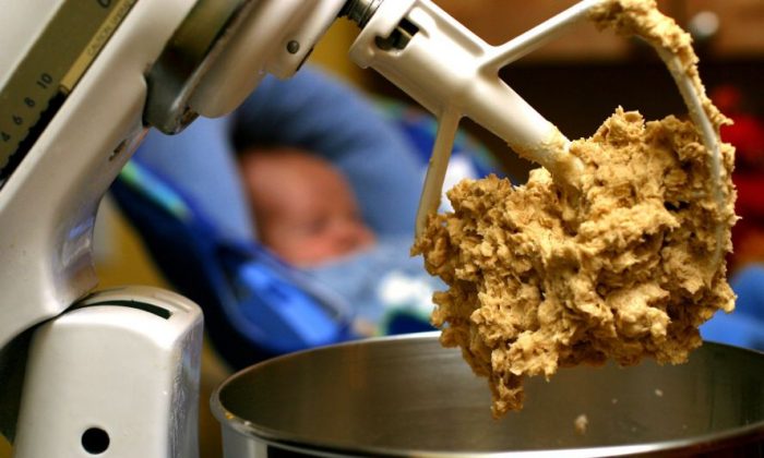In this undated file photo, cookie dough clings to the beaters of a standing mixer. Illnesses in 21 states traced to flour have left health officials puzzled about how the most basic baking ingredient became contaminated with bacteria normally found in animal feces. The Food and Drug Administration is cautioning consumers to never taste cookie dough or cake batter before it's cooked and clean up thoroughly after baking with flour. (AP Photo/Larry Crowe, File)
