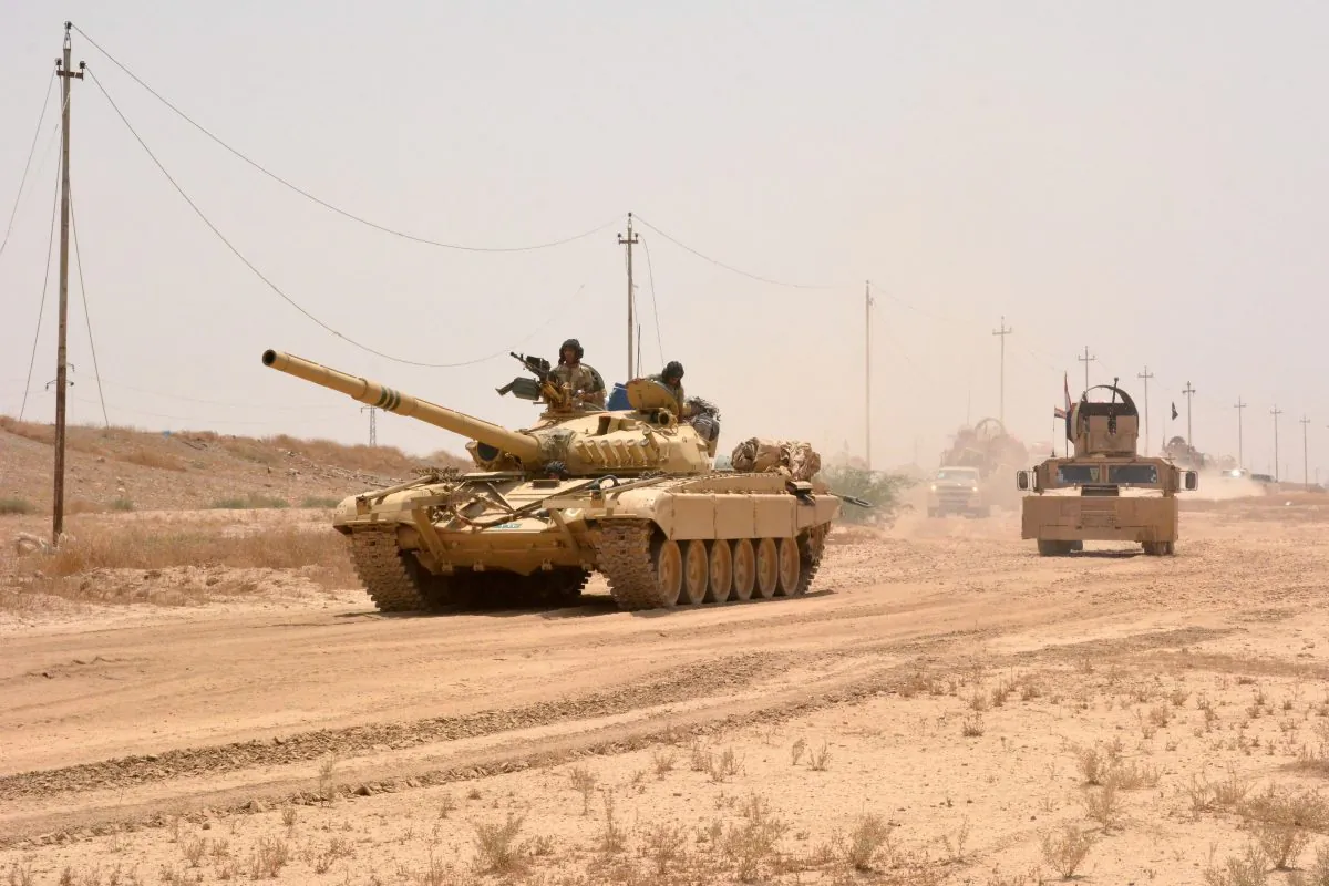 Iraqi government forces drive a tank some 25 miles west of Qayyarah, during their operation to take the city and make it a launchpad for Mosul on June 22, 2016. (Mahmud Saleh/AFP/Getty Images)