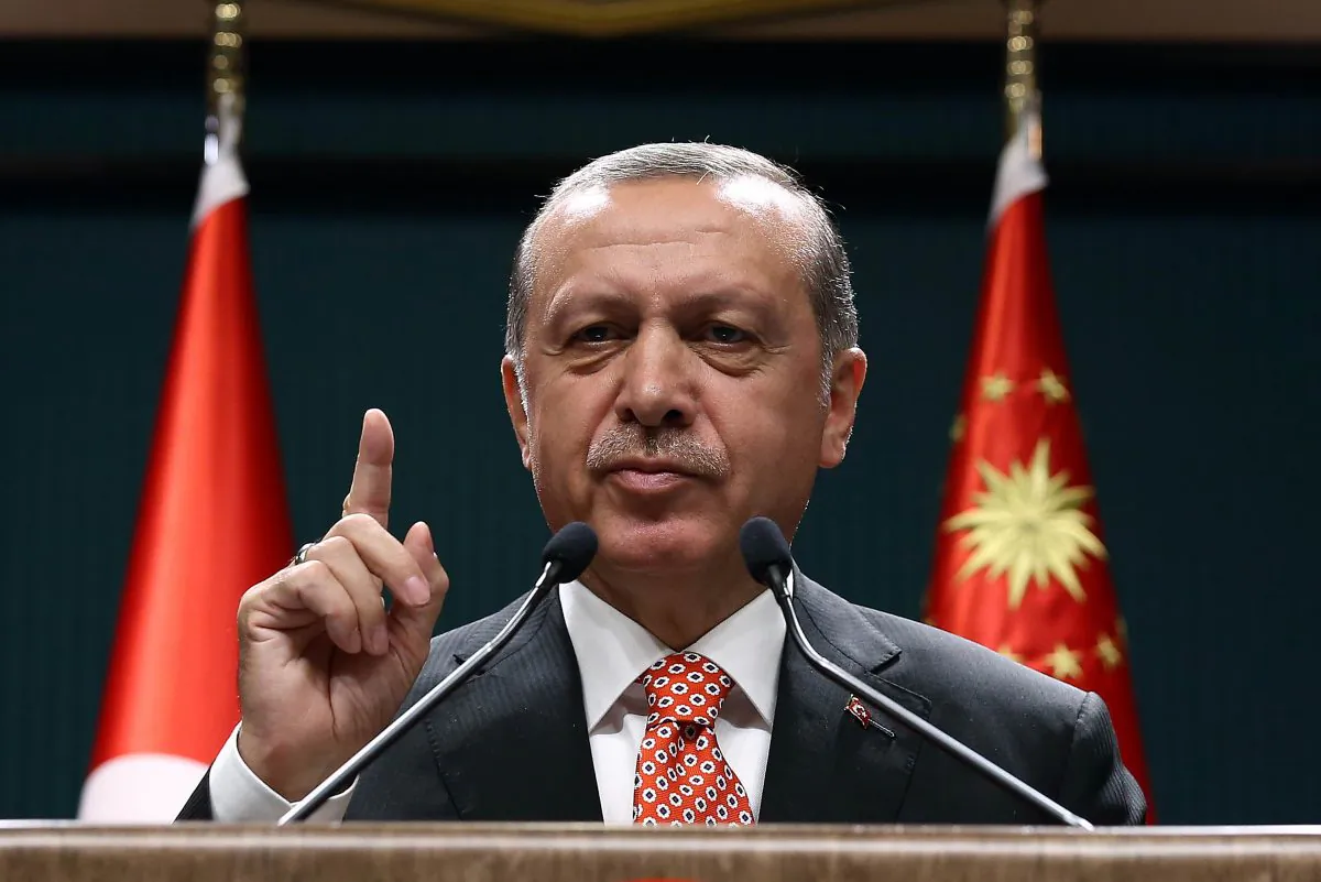 Turkish President Recep Tayyip Erdogan addresses people demonstrating against the failed military coup attempt in Turkey, via video conferencing at the Turkish Presidency in Ankara, Turkey, on July 24, 2016. (Yasin Bulbul/AFP/Getty Images)