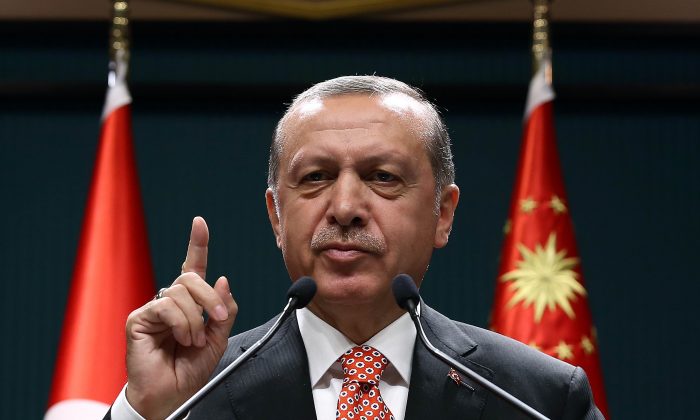 Turkish President Recep Tayyip Erdogan addresses people demonstrating against the failed military coup attempt in Turkey, via video conferencing at the Turkish Presidency in Ankara, Turkey, on July 24, 2016. (Yasin Bulbul/AFP/Getty Images)