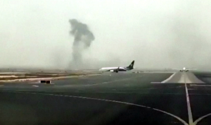 This image made from video shows smoke rising after an Emirates flight crash landed at Dubai International Airport on Wednesday, Aug. 3, 2016. (Hayen Ayari via AP)