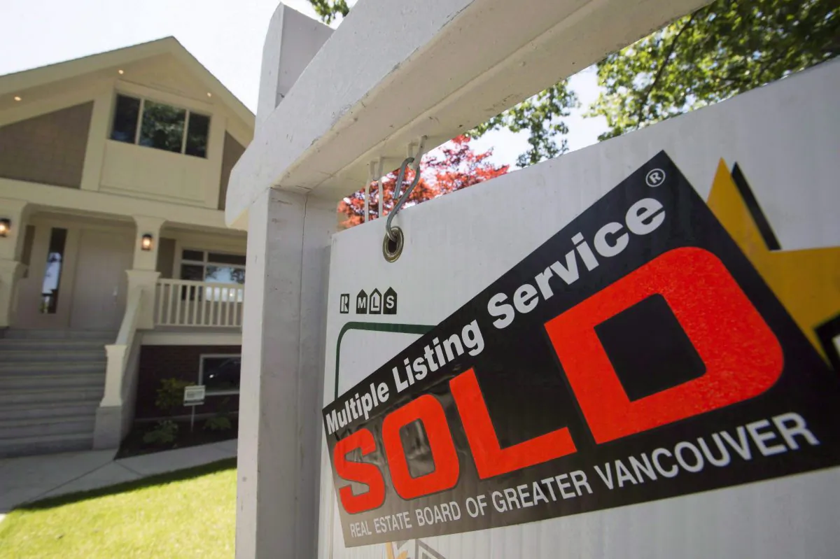 A sold sign is pictured outside a home in Vancouver in June. (The Canadian Press/Jonathan Hayward)