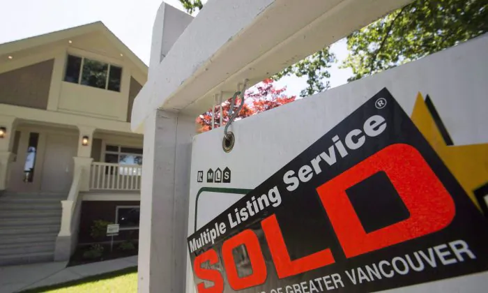 A sold sign is pictured outside a home in Vancouver in June. (The Canadian Press/Jonathan Hayward)