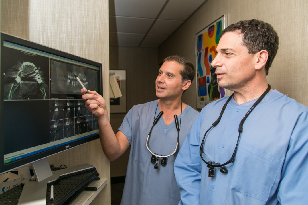 Dr. Chris Chondrogiannis (L) and Dr. John Lanzetta from Madison Avenue Periodontics at their office in Manhattan. N.Y. (Samira Bouaou/Epoch Times)