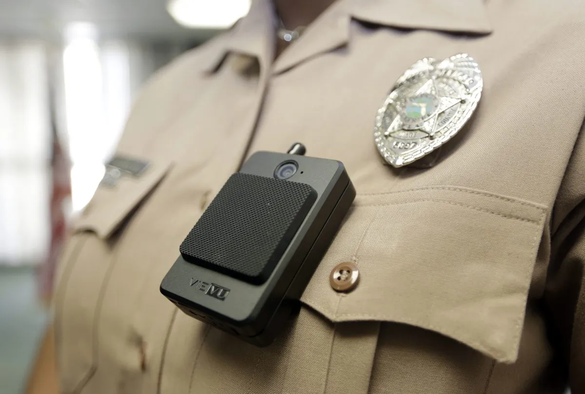 A body camera is worn by Miami-Dade Police Department PIO Marjorie Eloi, which 1,000 officers will begin using over the next few months, during a news conference, Thursday, April 28, 2016, in Doral, Fla. (AP Photo/Lynne Sladky)