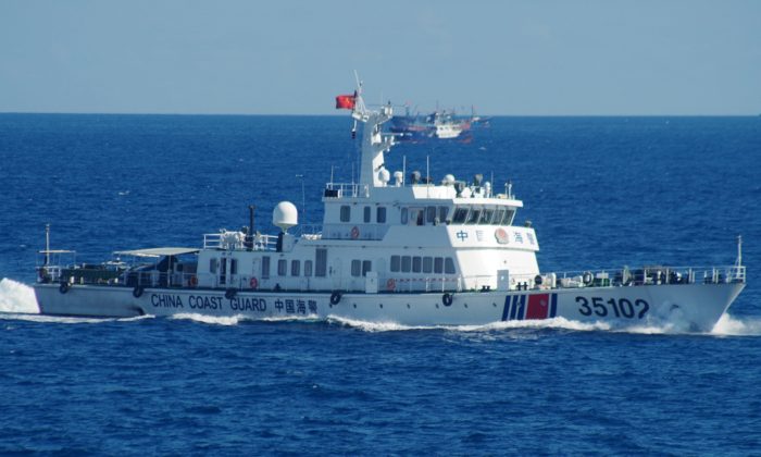 A Chinese coast guard vessel sails near disputed East China Sea islands on Aug. 6, 2016. Japan's Foreign Ministry said in a statement it filed the protest after Japan's coast guard spotted the vessels Saturday along with a fleet of 230 Chinese fishing boats swarming around the Japanese-controlled Senkaku Islands. China also claims the islands, calling them the Diaoyu. (11th Regional Coast Guard Headquarters via AP)