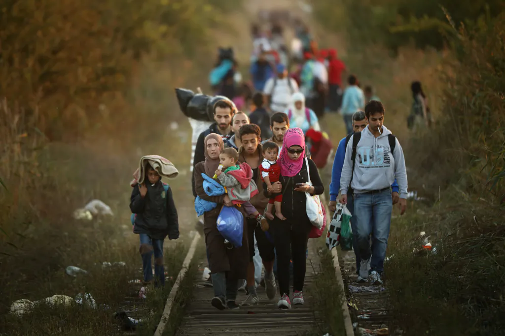 Migrants make their way through Serbia, near the town of Subotica, towards a break in the steel and razor fence erected on the border by the Hungarian government on Sept. 9, 2015. (Christopher Furlong/Getty Images)