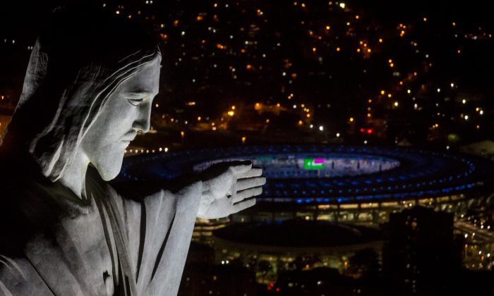 The Christ the Redeemer statue is seen at sunset in front of the Maracana Stadium ahead of the 2016 Summer Olympic Games in Rio de Janeiro, Brazil, on July 31, 2016. (Chris McGrath/Getty Images)