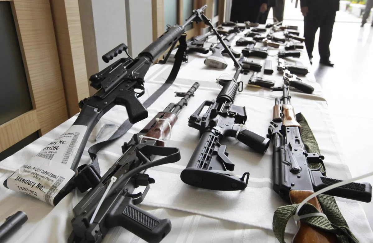 Various firearms seized from gun-owners who should not have passed an updated 2018 version of the NICS federal background check that includes mental heath information are displayed recently at the Chicago FBI office. (AP Photo/M. Spencer Green, File)