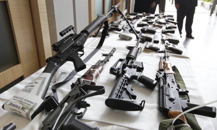 Various guns are displayed at the Chicago FBI office. A new poll shows most young adults across racial and ethnic groups support tighter gun policies including background checks, stricter penalties for gun law violations, and banning semi-automatic weapons. (AP Photo/M. Spencer Green, File)
