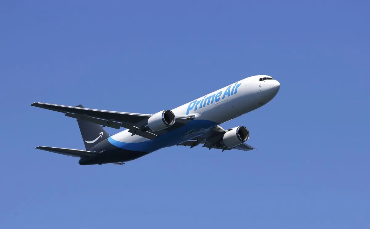 A Boeing 767 with an Amazon.com "Prime Air" livery flies over Lake Washington, Friday, Aug. 5, 2016, as part of the Boeing Seafair Air Show. Amazon unveiled its first branded cargo plane Thursday, one of 40 freighters that will make up the company's own air transportation network of 40 Boeing jets leased from Atlas Air and Air Transportation Services Group, which will operate the air cargo network. (AP Photo/Ted S. Warren)