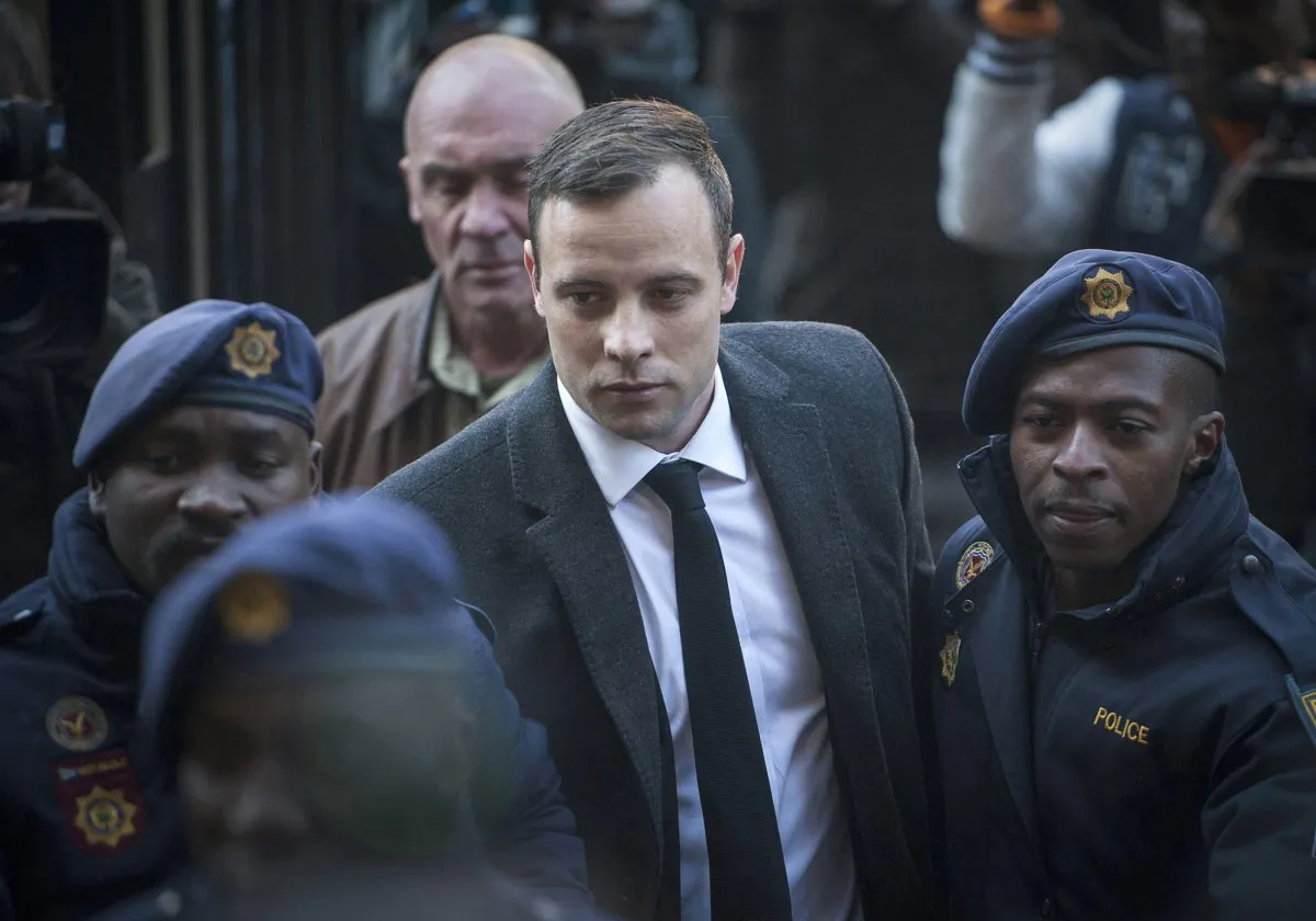 FILE - Oscar Pistorius, center, arrives at the High Court in Pretoria, South Africa, for a sentencing hearing for the murder of his girlfriend Reeva Steenkamp. (AP Photo/Shiraaz Mohamed, File)