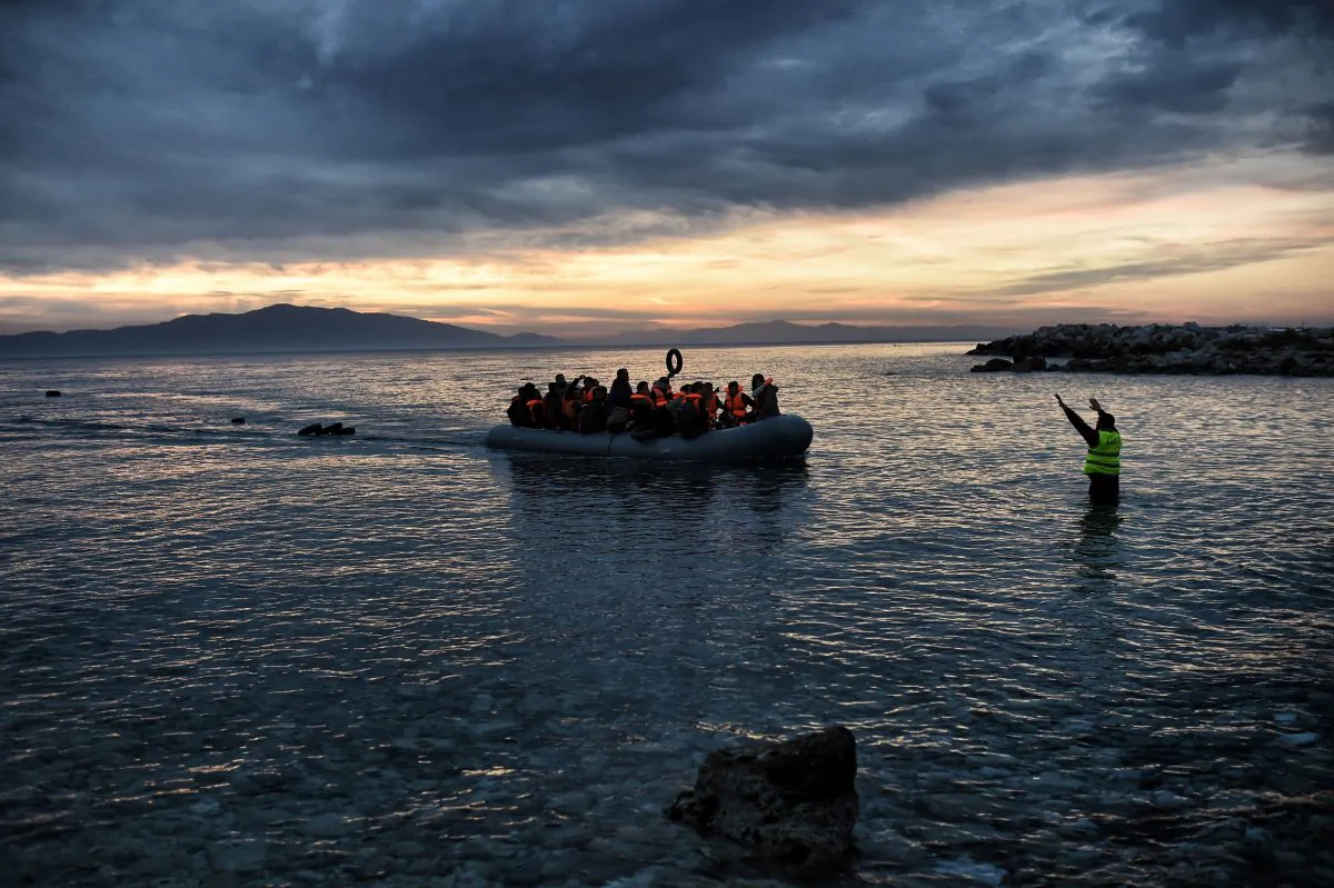 Refugees and migrants massed onto an inflatable boat reach Mytilene, northern island of Lesbos, after crossing the Aegean sea from Turkey, on Febr. 17, 2016. (Aris Messinis/AFP/Getty Images)