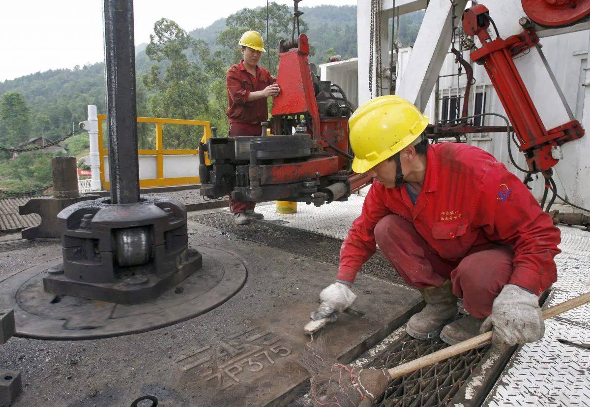 In a file photo, employees work on a drill well at a Sinopec exploration site in the Longgang gas field in Lishan, Sichuan Province. (Liu Jin/AFP/Getty Images)