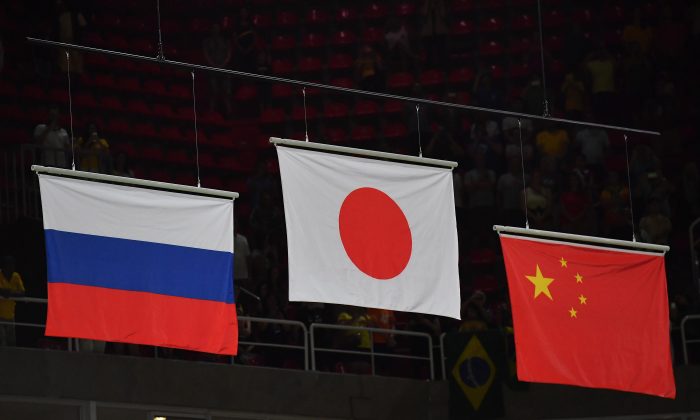 From left to right: Russian, Japanese and Chinese flags displayed at the Olympic arena, after the men's team final of the Artistic Gymnastics during the Rio 2016 Olympic Games on August 8, 2016. (BENSTANSALL/AFP/GettyImages)