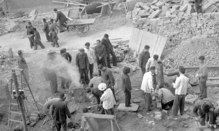 Employees of the Shin Chiao Hotel in Beijing build in the hotel courtyard (background) in October 1958 a small and rudimentary smelting steel furnace during the period of the "Great Leap Forward. (JACQUET-FRANCILLON/AFP/Getty Images)