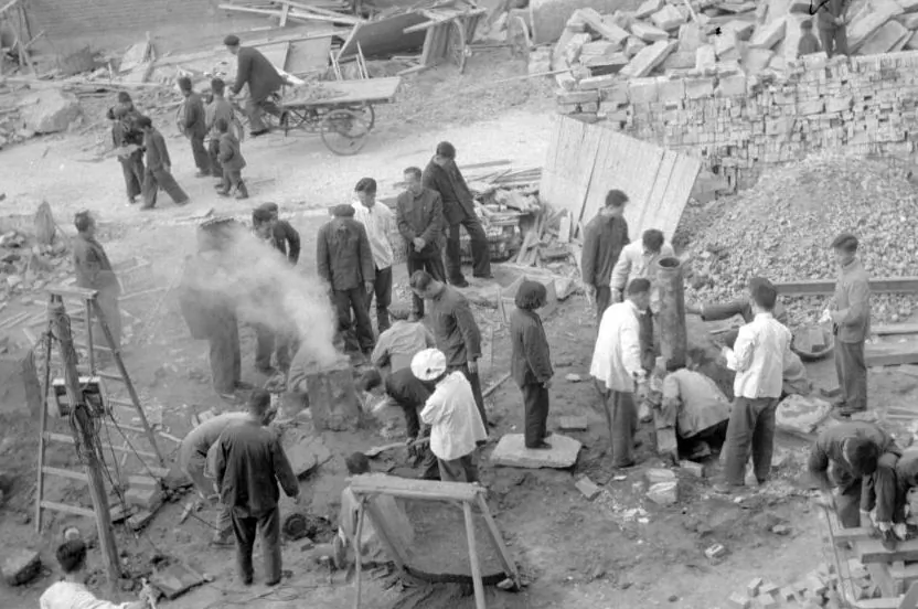 Employees of the Shin Chiao Hotel in Beijing build in the hotel courtyard (background) in October 1958 a small and rudimentary smelting steel furnace during the period of the "Great Leap Forward. (JACQUET-FRANCILLON/AFP/Getty Images)