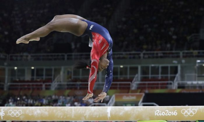 United States' Simone Biles performs on the balance beam during the artistic gymnastics women's qualification at the 2016 Summer Olympics in Rio de Janeiro, Brazil, Sunday, Aug. 7, 2016. (AP Photo/Rebecca Blackwell)