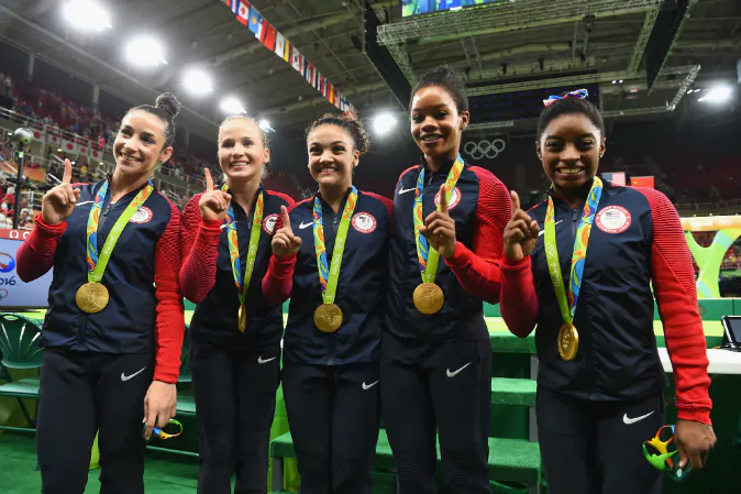 (L to R) Gold medalists Alexandra Raisman, Madison Kocian, Lauren Hernandez, Gabrielle Douglas and Simone Biles of the United States pose for photographs with their medals after the medal ceremony for the Artistic Gymnastics Women's Team on Day 4 of the Rio 2016 Olympic Games at the Rio Olympic Arena in Rio de Janeiro, Brazil on August 9, 2016. (Laurence Griffiths/Getty Images)