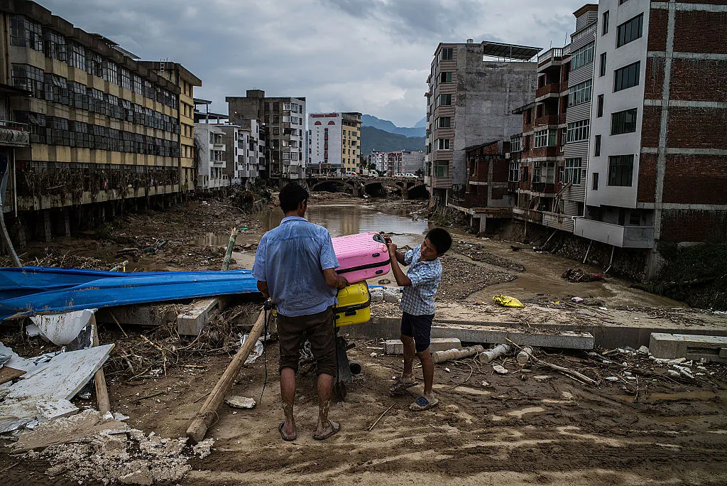 People leave home in the damaged village at Bandong Town on July 12, 2016 in Fuijan, China. (Lam Yik Fei/Getty Images)