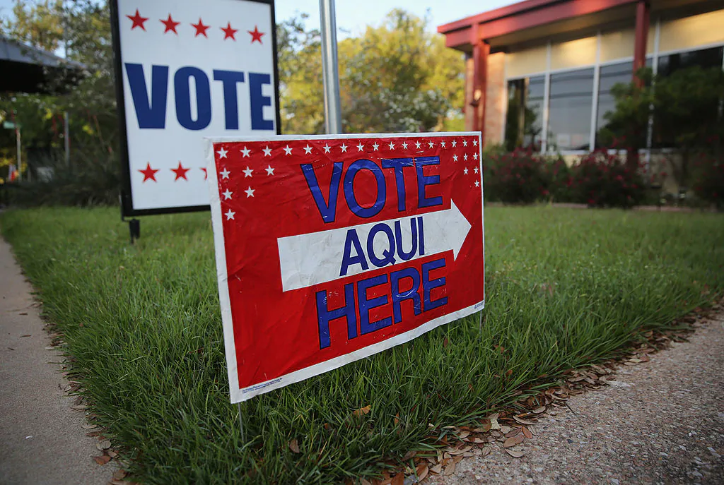 A bilingual sign stands outside a polling center at public library ahead of local elections in Austin, Texas, on April 28, 2013. (John Moore/Getty Images)
