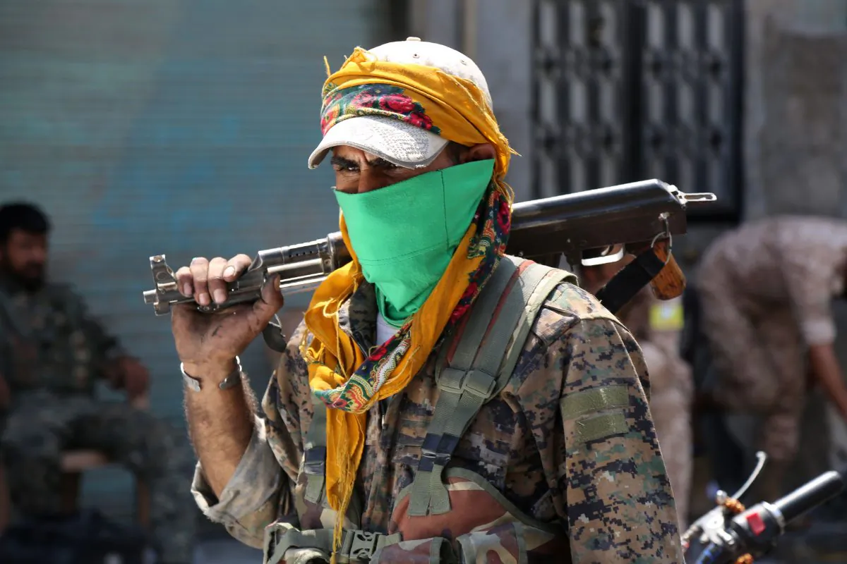 A member of the Syrian Democratic Forces (SDF) walks on a street in the northern Syrian town of Manbij on Aug. 7, 2016. (Delil Souleiman/AFP/Getty Images)