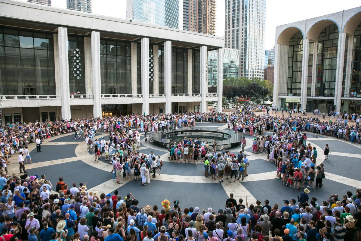 One thousand people from around the community participate in a group song and  performance on Lincoln Center's plaza called "the public domain," written by David Lang, in New York on Aug. 13, 2016. (Benjamin Chasteen/Epoch Times)