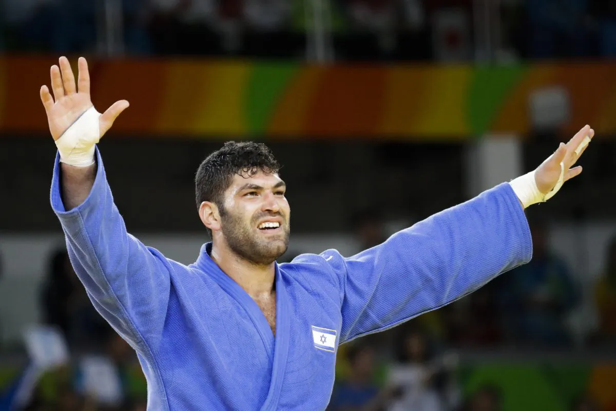Israel's Or Sasson celebrates after winning the bronze medal during the men's over 100-kg judo competition at the 2016 Summer Olympics in Rio de Janeiro, Brazil, on Aug. 12, 2016. (AP Photo/Markus Schreiber)