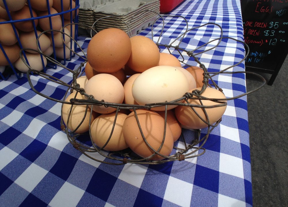 Eggs from Kepner Farms in a basket at a farmers market booth. (Reyn H./Yelp)